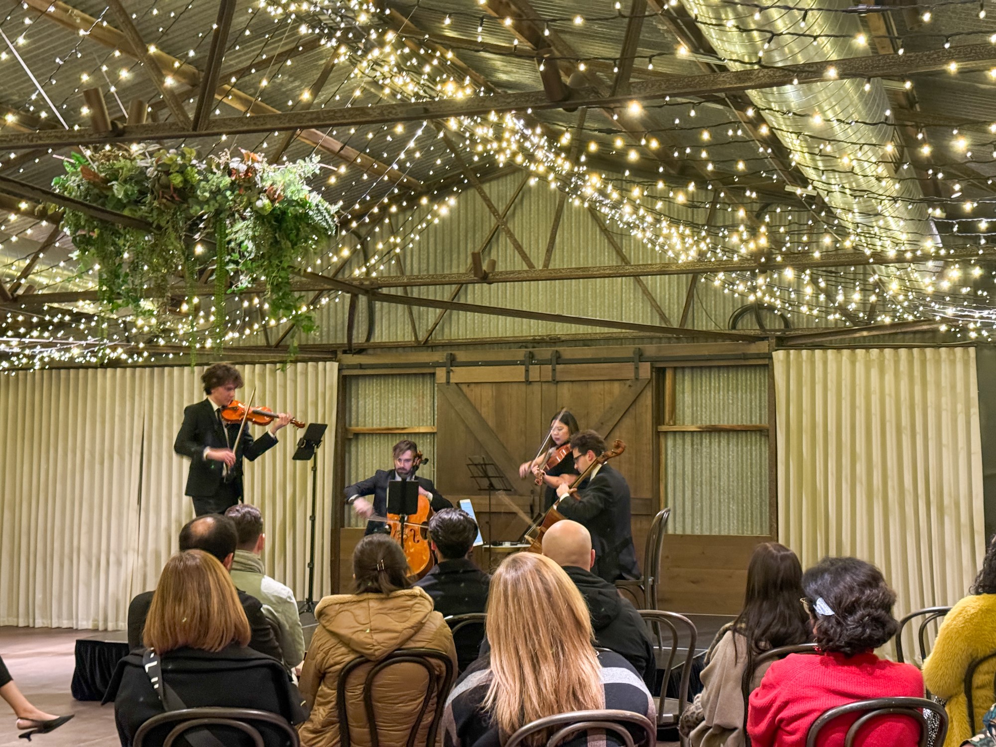 Quartet playing with audience in foreground