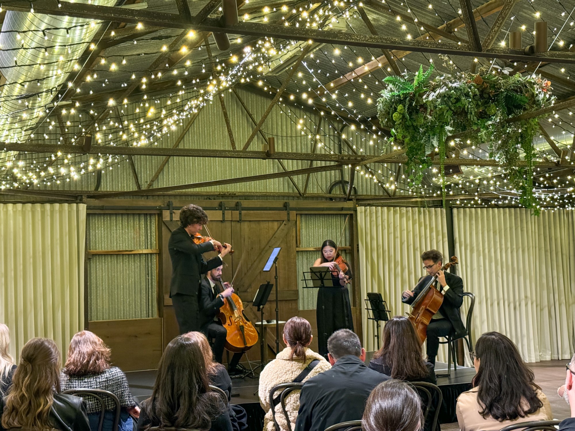 Quartet playing with audience in foreground