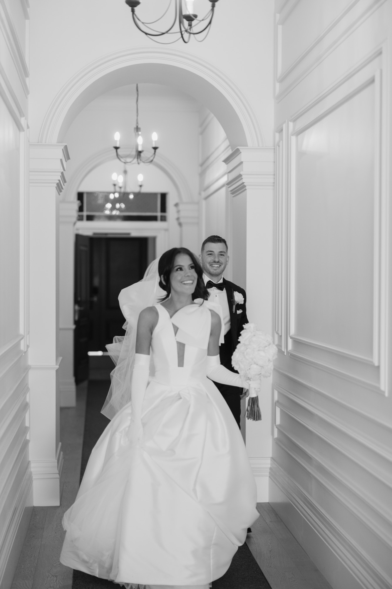 A bride and groom in the arched hallway of The Homestead at Marnong Estate