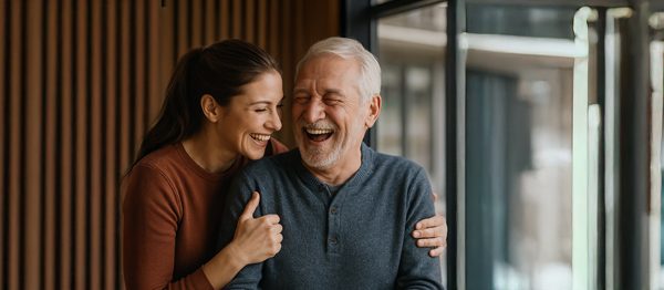 Daughter hugging and laughing with her father while celebrating Father’s Day