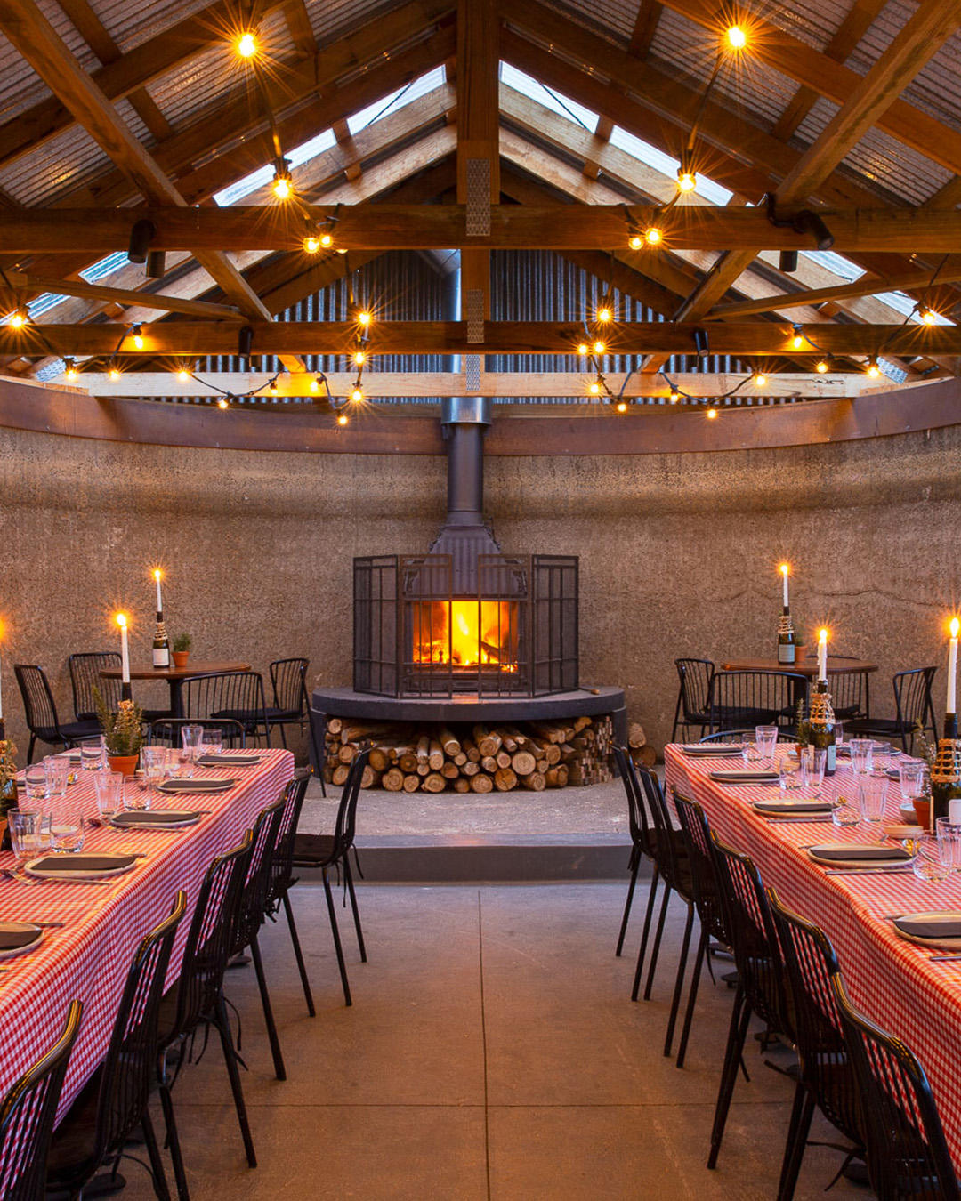Nonna’s Shed dining room set up and ready for guests with long tables, ambient lighting and wine glasses prepared